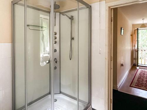 a shower with a glass door in a bathroom at Woodside Fishery - The Mallards in Cleobury Mortimer