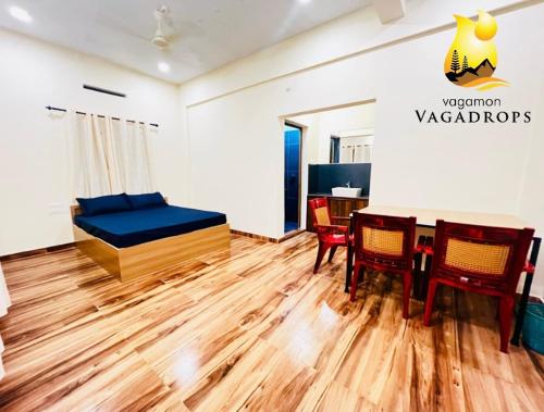 a room with a bed and a table and chairs at VAGAMON VAGADROPS in Vagamon