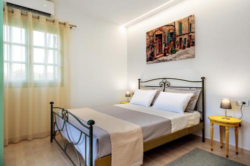 a bedroom with a bed with a picture on the wall at Argiros House in Chania Town