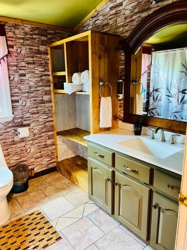 a bathroom with a sink and a toilet at Alwar House: A mountain paradise in Piney Creek