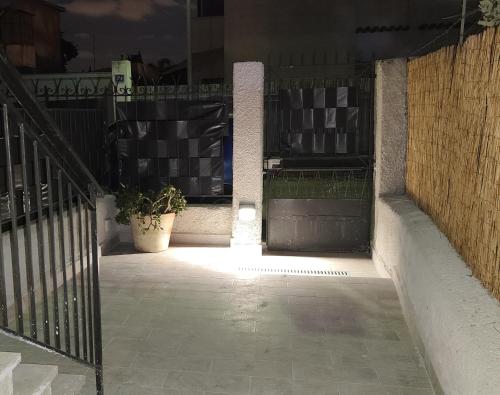 an open door of a building with a potted plant at Villebe Mondello in Mondello
