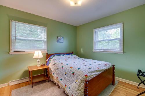 a bedroom with a bed and two windows at Quaint Horseheads Home about 9 Mi to Elmira College in Horseheads