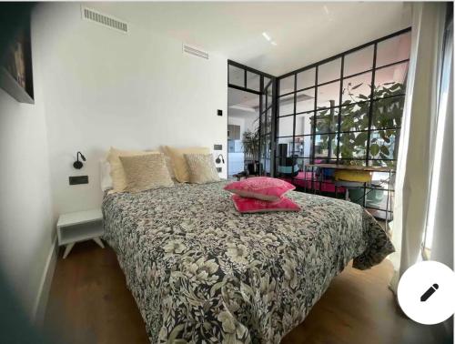 a bedroom with a bed and a large window at Apartamento Precioso Marbella Paseo Maritimo in Marbella