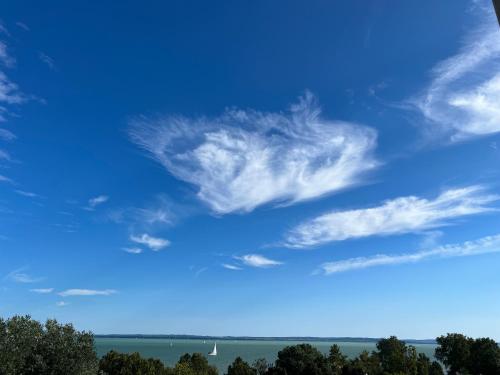 a blue sky with some clouds in the sky at Club Panorama Lake View Apartment in Alsóörs
