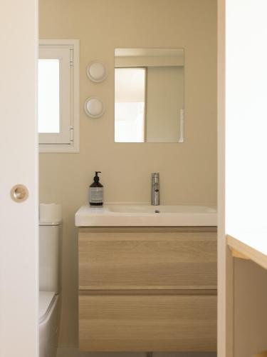 a bathroom with a sink and a mirror at wecamp Cadaqués in Cadaqués