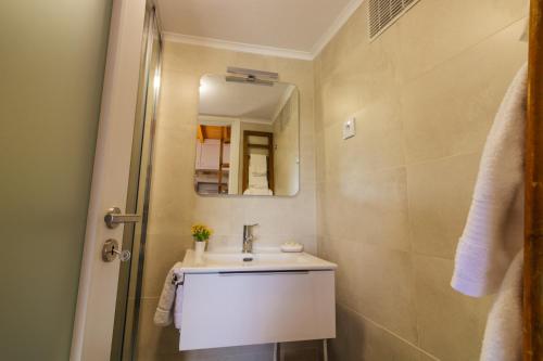 a bathroom with a sink and a mirror at CHALÉ in Alijó