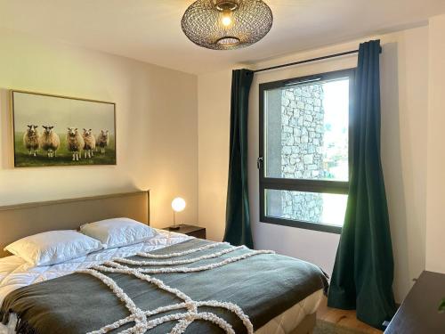 une chambre avec un lit et une fenêtre avec un troupeau de moutons dans l'établissement Les Gets - Appartement dans une résidence neuve - FR-1-623-4, aux Gets