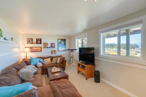 a living room with a couch and a television at Stunning Home in Coupeville with Deck and Beach Access in Coupeville