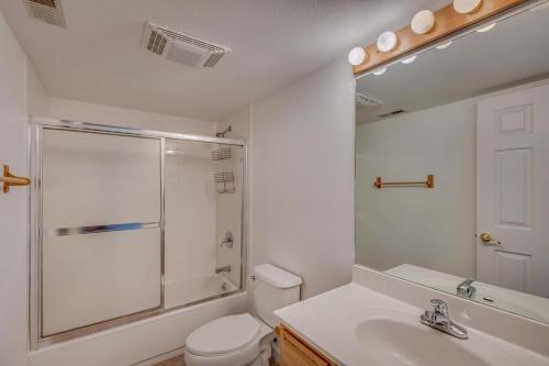 a bathroom with a shower and a toilet and a sink at 1032 Luxury Eaglepointe Townhome in Steamboat Springs