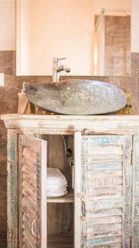 a sink on top of a wooden cabinet in a bathroom at Bed & Breakfast Corte Toro in Lucca