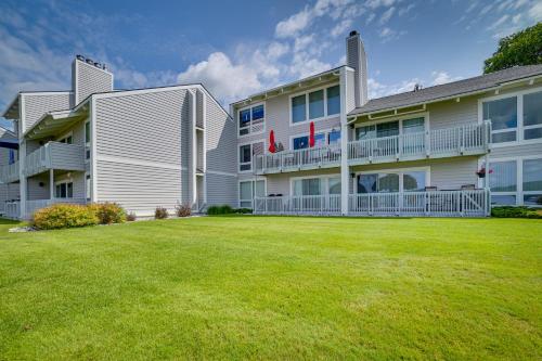 a large yard in front of a building at Luxury Lakefront Boyne City Townhome with Views! in Boyne City