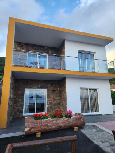 a house with a bench in front of it at Rosegarden View in Velas