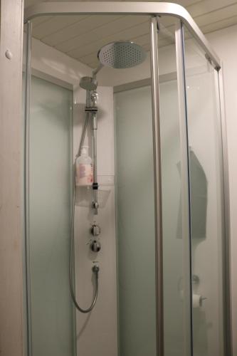 a shower in a bathroom with a glass door at Villa Hattu in Naantali
