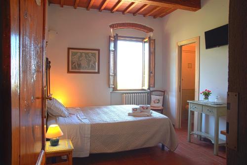 Ένα ή περισσότερα κρεβάτια σε δωμάτιο στο Agriturismo Il Calesse