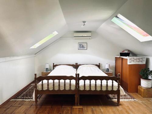 a bedroom with a bed in a attic with skylights at Apartments Bilić in Vis