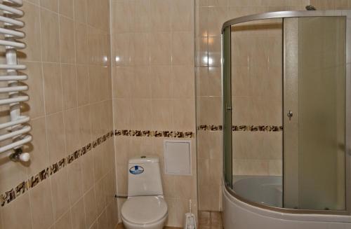 a bathroom with a toilet and a sink and a shower at Stupari in Shaian