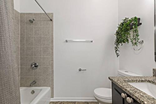 a bathroom with a toilet and a sink and a shower at The Penthouse, Lux stay near Downtown, UofC & Lake in Chicago