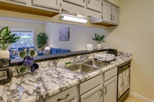 a kitchen with a sink and a counter top at Tallahassee Townhome with Patio Near FSU Campus! in Tallahassee