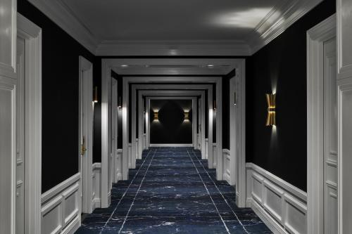 a corridor with black walls and a long hallway with black ceilings at The LaSalle Chicago, Autograph Collection by Marriott in Chicago