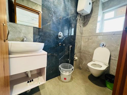 a bathroom with a sink and a toilet at HOTEL ROYAL VANILLA in Siliguri