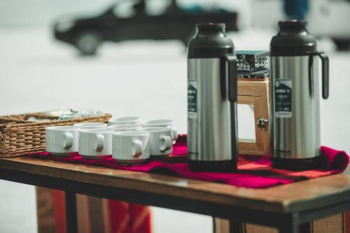 a table with two thermos on top of a table at Hotel de Sal Luna Salada in Colchani