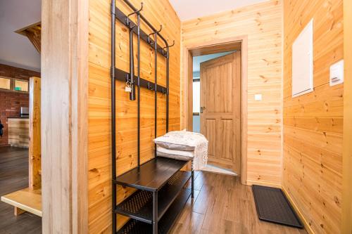 a hallway with wood paneling and a bench in a room at Kolorowe Karkonosze in Przesieka