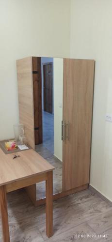 a room with a wooden table and a mirror at Hotel SESIL in Gyumri