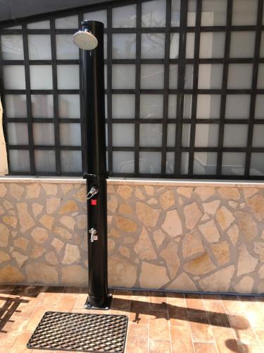 a metal garage door with a black pole and a gate at Ma. De House Lago del Turano in Valle Verde