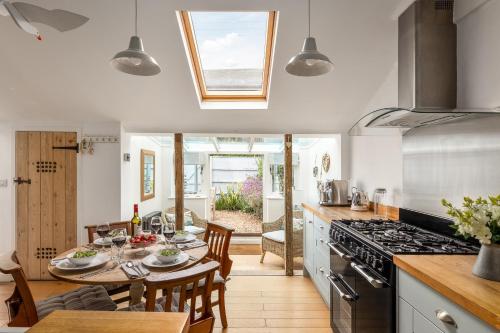 a kitchen with a table and a dining room at 7 Church Street, Southwold in Southwold