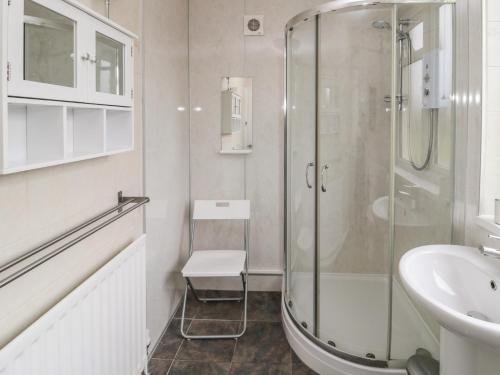 a bathroom with a shower and a sink at Seaview Howick in Craster