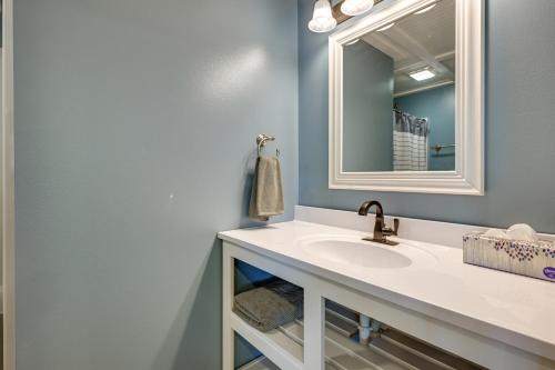 a bathroom with a sink and a mirror at Chippewa Falls Getaway with Community Lake Access! in Chippewa Falls