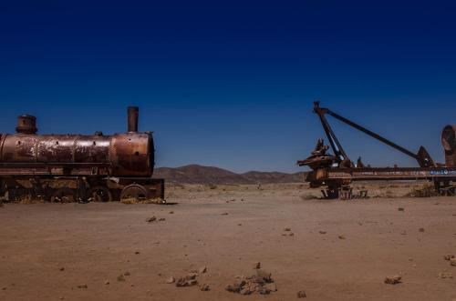 an old train in the middle of the desert at Hotel de Sal Luna Salada in Colchani