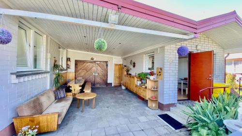 a living room with a couch and a table at Alyvų Vila - Palanga All House Just For You in Palanga