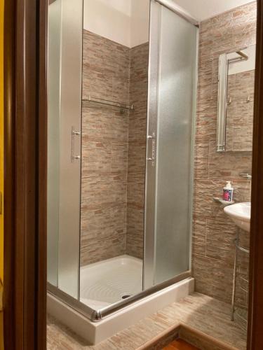 a shower with a glass door in a bathroom at Araxi in Villa San Pietro