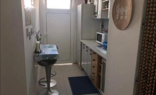 a small kitchen with a sink and a refrigerator at My House Urban in Arrecife