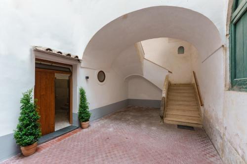 a hallway with a staircase in a building at Anima Suite - Sauna - Jacuzzi e Cucina in Procida