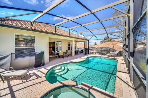 a swimming pool on a patio with a house at WH7783TB-Windsor Hills- 10 guests - in Orlando