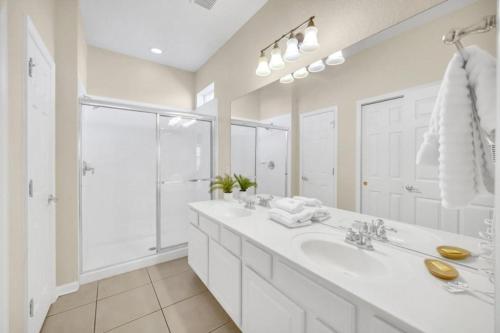 a white bathroom with a sink and a shower at WH7783TB-Windsor Hills- 10 guests - in Orlando