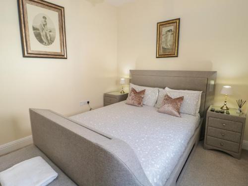 a bedroom with a large bed with two night stands at The Moorings in Deganwy