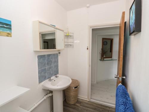 a bathroom with a sink and a mirror at Seaview Central in Southsea