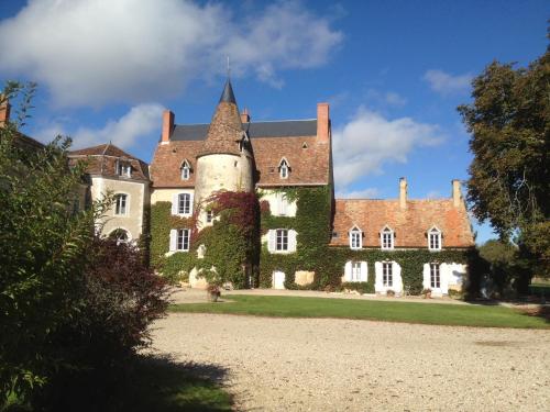 an old castle with a turret on a lawn at Le Sequoia in Velles