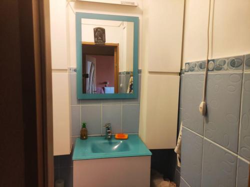 a bathroom with a blue sink and a mirror at Dorobantilor House in Cluj-Napoca