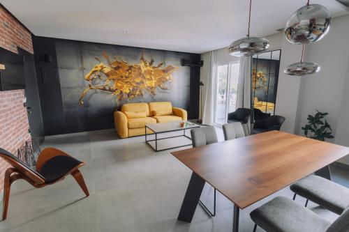 a living room with a table and a yellow couch at Vallia Suites-Yellow Luxury Suite A1 in Nafpaktos