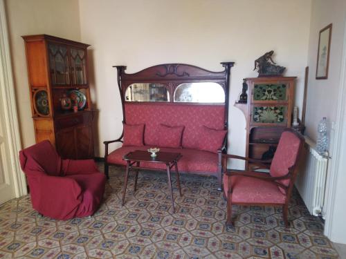 a living room with a couch and two chairs and a table at FORESTERIA DEL TEATRO in Agrigento