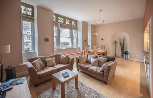 a living room with two couches and a table at Cloister View in Fort Augustus