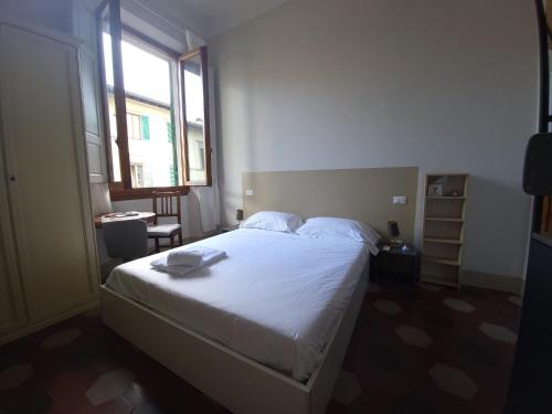 a bedroom with a bed in a room with a window at Homely studio flat 10 minutes from the city centre in Florence