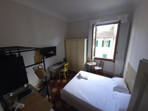 a small bedroom with a bed and a window at Homely studio flat 10 minutes from the city centre in Florence