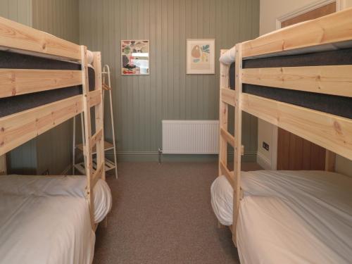 a room with two bunk beds in it at Gudhjem in Seahouses