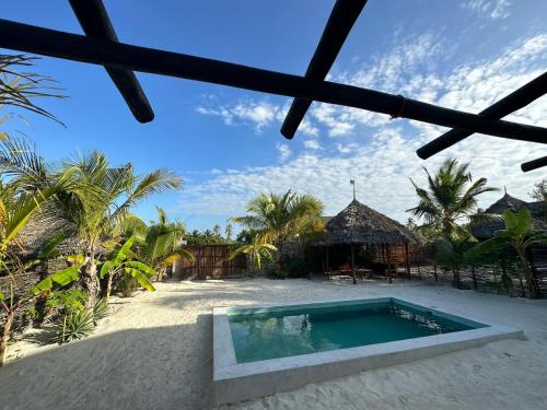 a swimming pool in the middle of a resort at Maracuja villa Zanzibar in Bwejuu