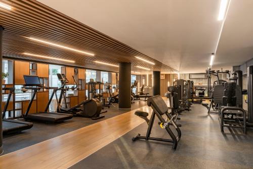 a gym with several treadmills and machines in a room at Andaz Condesa Mexico City, By Hyatt in Mexico City